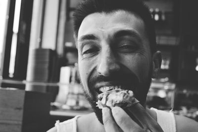 Close-up portrait of man eating food