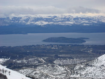 Aerial view of snowcapped mountains against sky