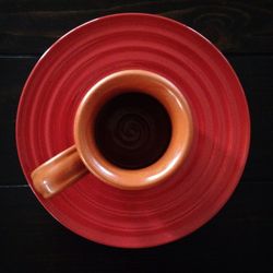 Directly above shot of spiral object over black background