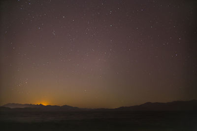 Scenic view of mountains against sky at night