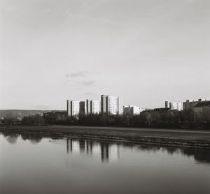 Reflection of buildings in lake against sky