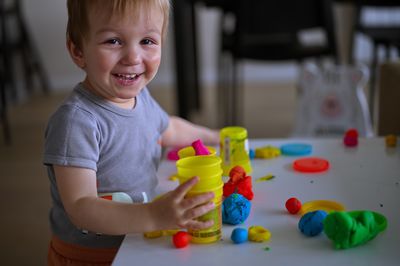 Close-up of boy playing with toys on table