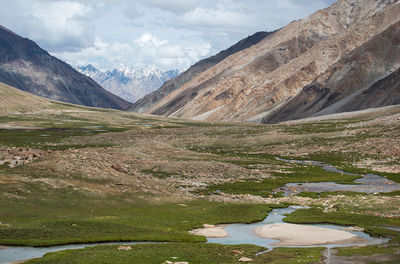 Scenic view of landscape and mountains against sky