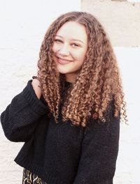 Portrait of smiling young woman with curly hair