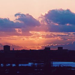 Silhouette of building against dramatic sky