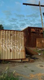 Graffiti on old building against sky