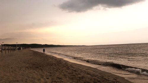 Scenic view of beach against sky during sunset