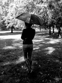 Rear view of man and woman walking in park