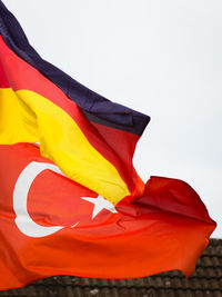 Low angle view of flag against clear sky