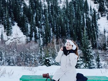 Young woman on snow covered land