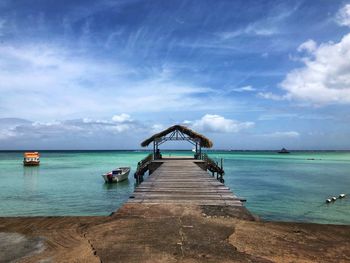 Pier over sea against sky