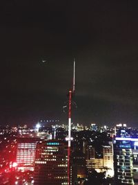 Illuminated city against sky at night