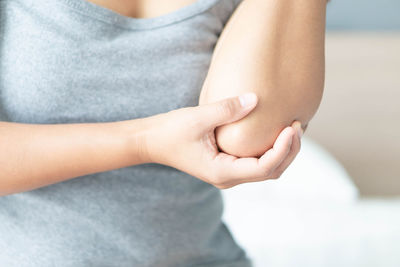 Midsection of woman touching hair