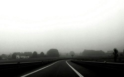 Road passing through foggy weather
