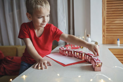 Boy playing with toy blocks at home