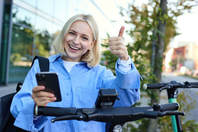 Portrait of young woman using mobile phone