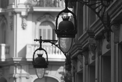 Low angle view of illuminated lamp hanging on ceiling of building