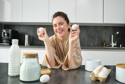 Midsection of woman having breakfast at home