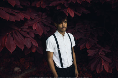 Portrait of young man standing at night