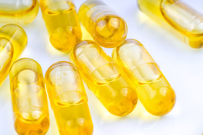 Close-up of yellow bottle against white background