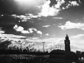 View of cityscape against cloudy sky