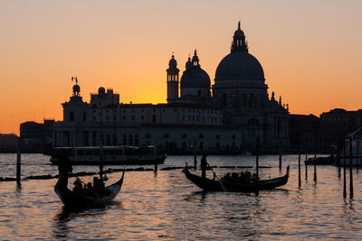 View of gondolas on river at sunset