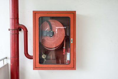 Fire hose on white wall