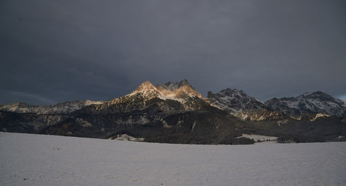 Scenic view of snowcapped mountains against sky during winter