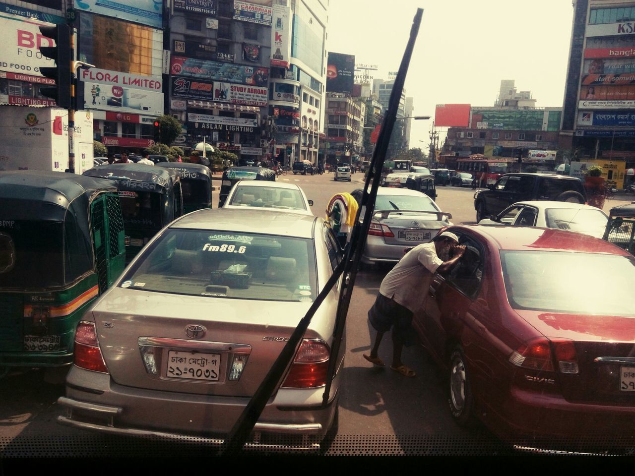 transportation, land vehicle, car, mode of transport, building exterior, architecture, city, street, built structure, city street, city life, traffic, road, travel, incidental people, on the move, vehicle, bus, day