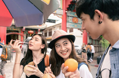 Portrait of happy woman holding people in market