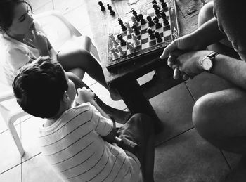 High angle view of family playing chess at home