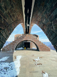 Arch bridge against sky during winter