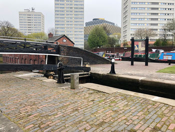 Footpath by buildings in city