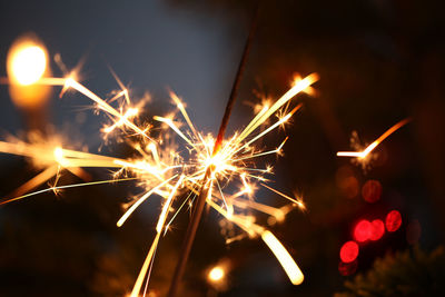 Close-up of burning sparkler at night
