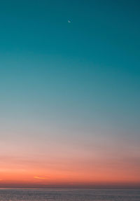 Scenic view of sea against clear sky during sunset