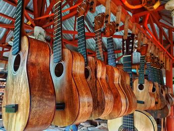 Close-up of guitars hanging for sale