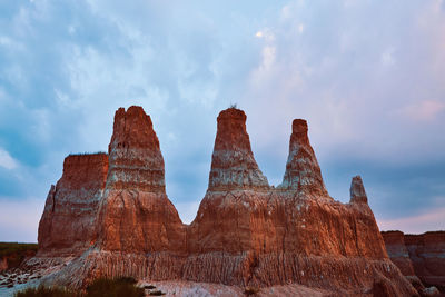 View of rock formation against cloudy sky