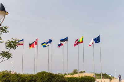 Low angle view of flag flags against sky