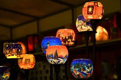 Close-up of illuminated lanterns hanging at market