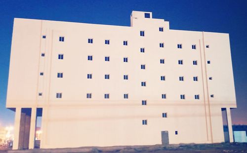 Low angle view of building against clear blue sky