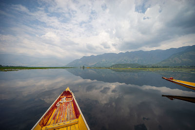 View over traditional boat or shikara - a type of wooden boat at dal lake, khasmir. 
