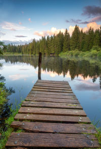 Pier over lake against sky