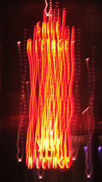 Close-up of illuminated fire against black background