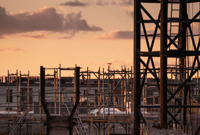 Scaffolding against sky during sunset