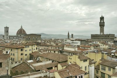 Cityscape against cloudy sky