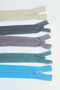 Close-up of blue colored pencils against white background