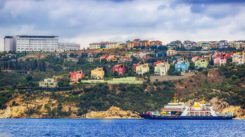 Boats in river with buildings in background