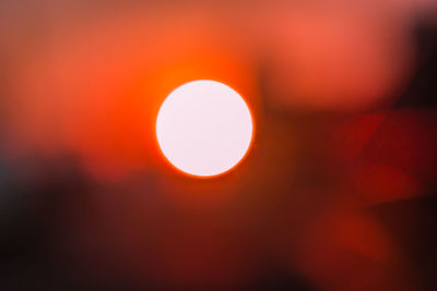 Defocused image of sun against sky during sunset