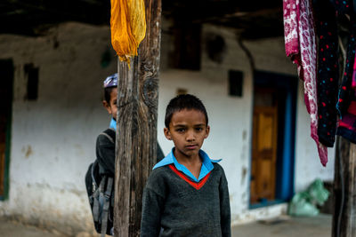 Children standing against building