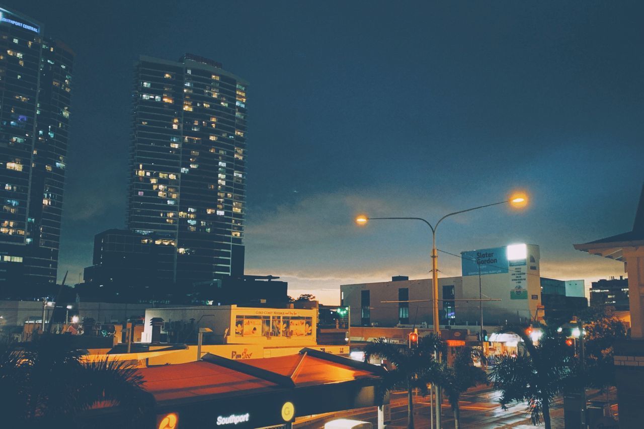 ILLUMINATED BUILDINGS IN CITY AT NIGHT